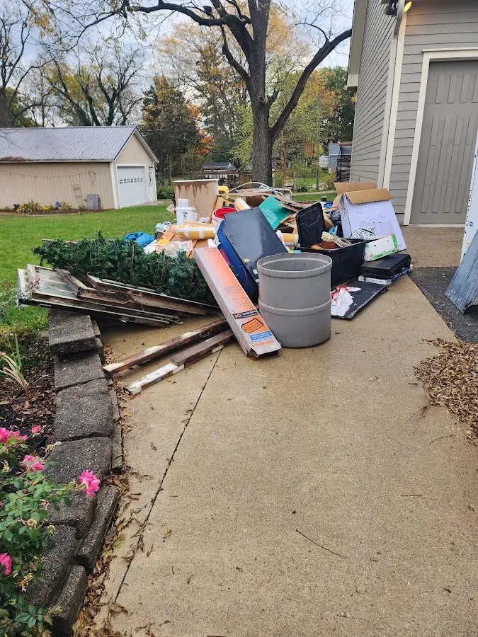Dumpster being loaded with debris for Estate Cleanout Dumpster Rental in Pemberton